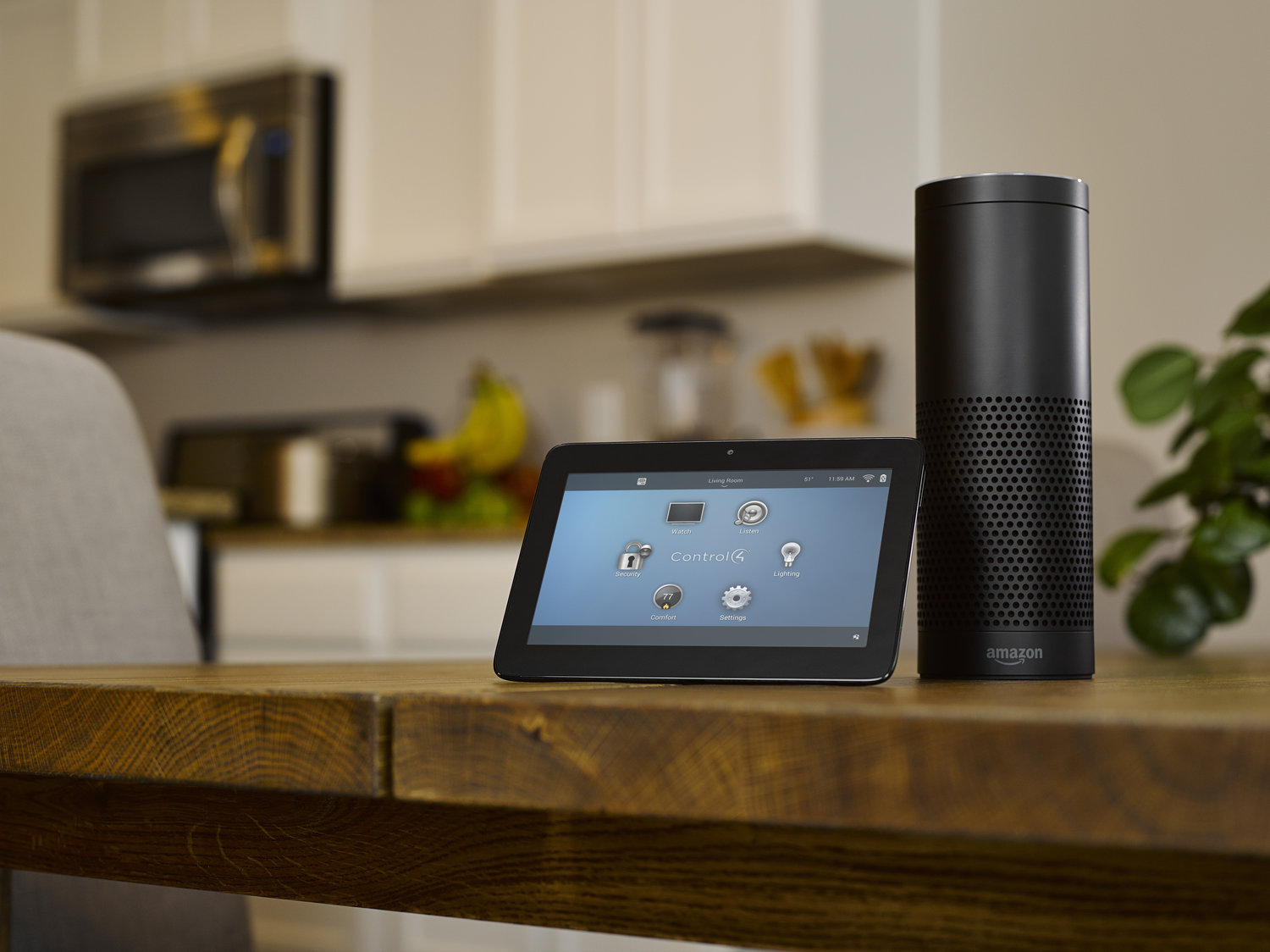 Control4 smart home solutions interface on a tablet in a kitchen next to wireless speaker
