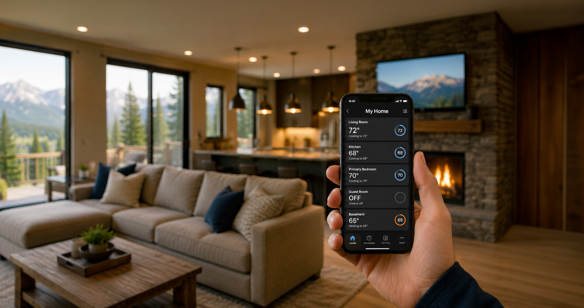 Hand holding a smartphone displaying room temperatures in a mountain-view living room with fireplace and sofa.